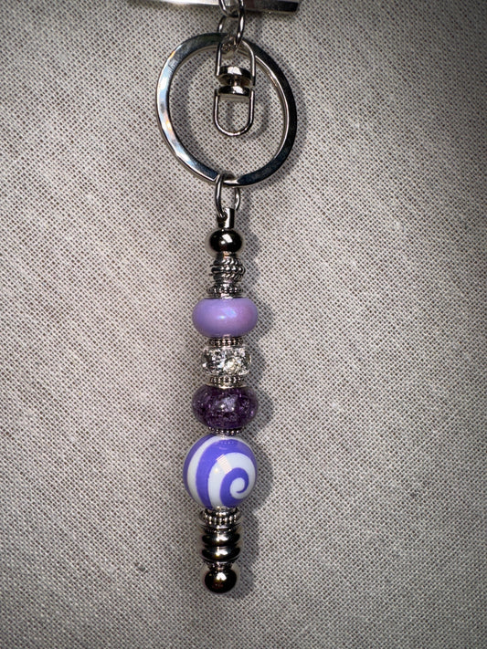 A swirl of color, a touch of charm Handmade Purple Swirl Beaded Keychain